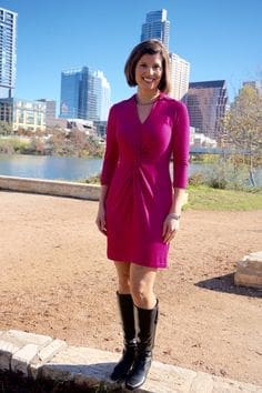 Smiling woman in magenta dress by urban waterfront Smiling woman in magenta dress by urban waterfront