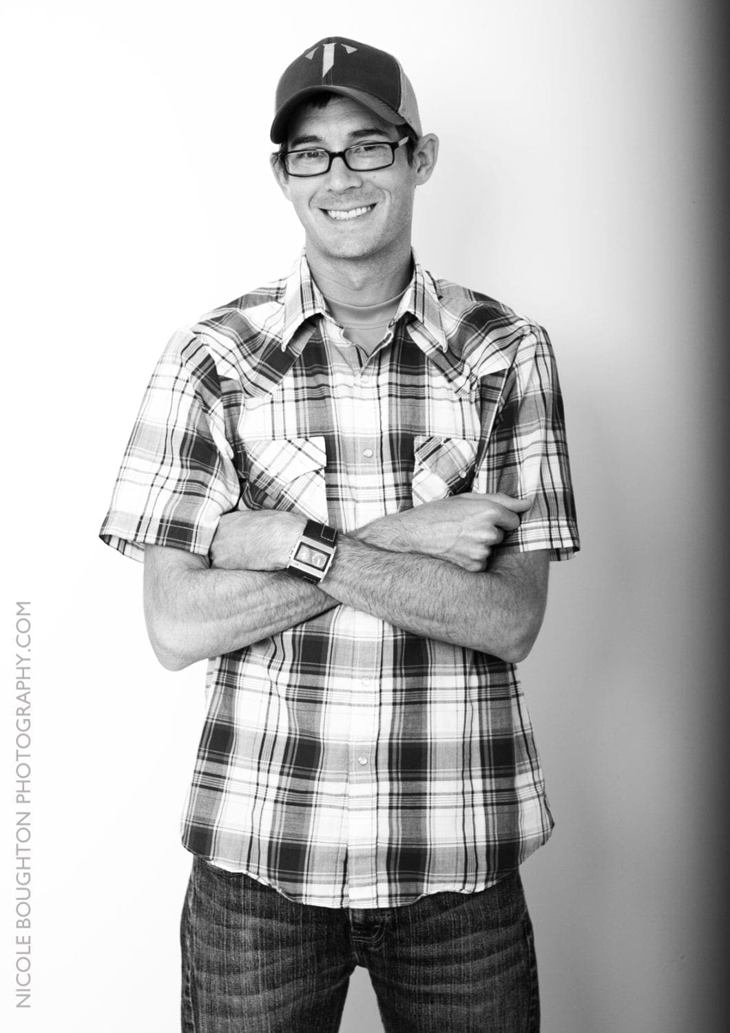 Smiling man in plaid shirt and cap Smiling man in plaid shirt and cap