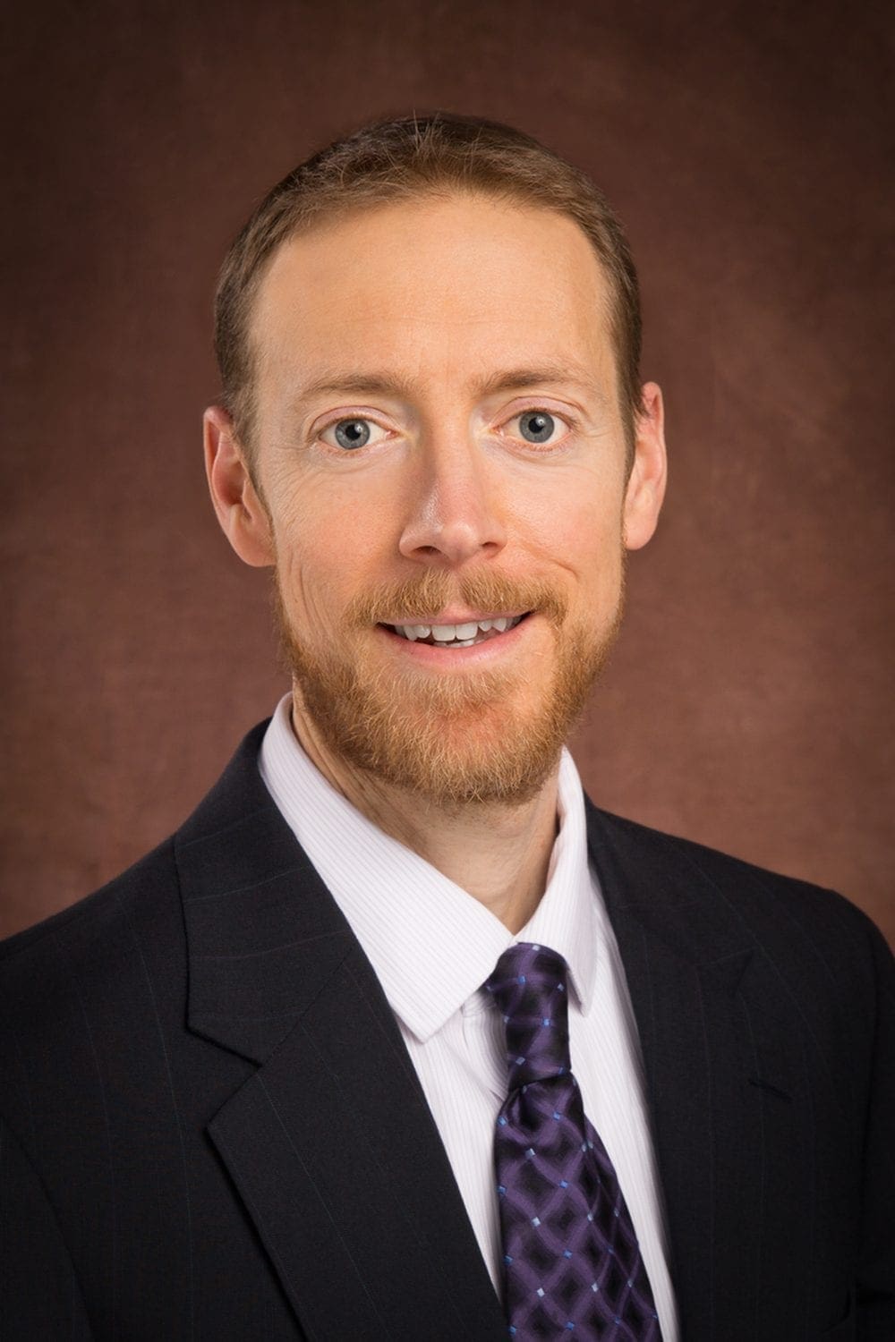 Smiling professional headshot of man in suit Smiling professional headshot of man in suit