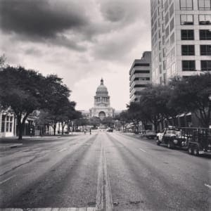 Empty city street leading to domed capitol building