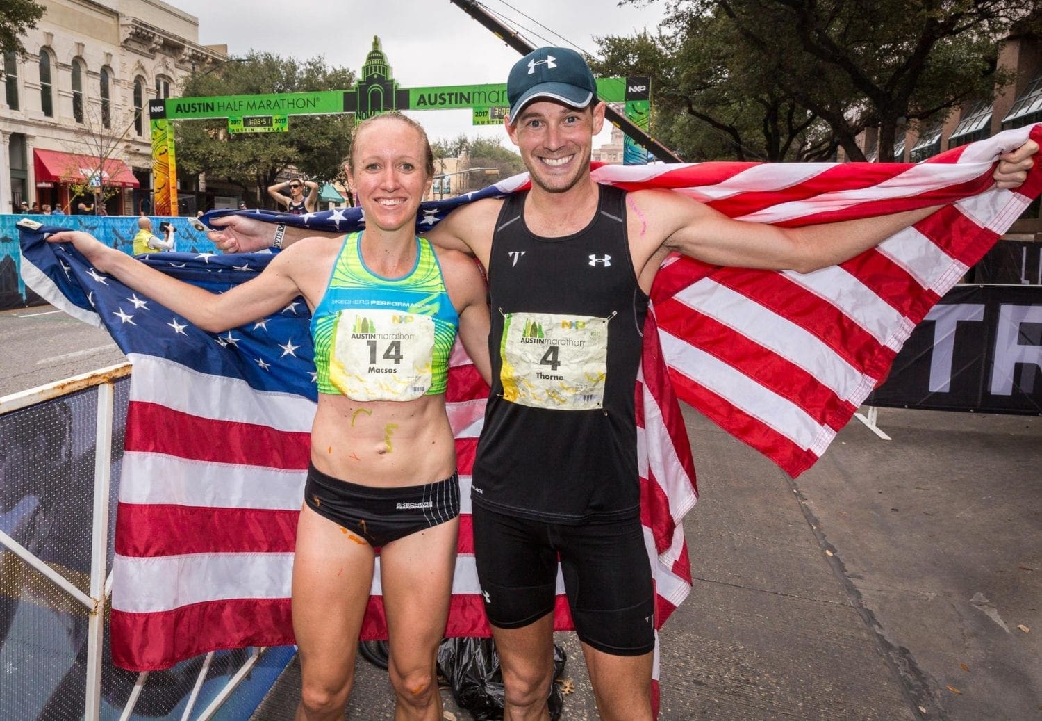 Austin Half Marathon finishers holding American flags