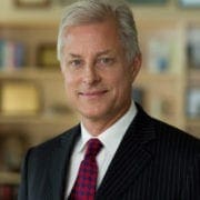 Smiling gray-haired man in suit and tie