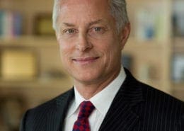 Smiling gray-haired man in suit and tie