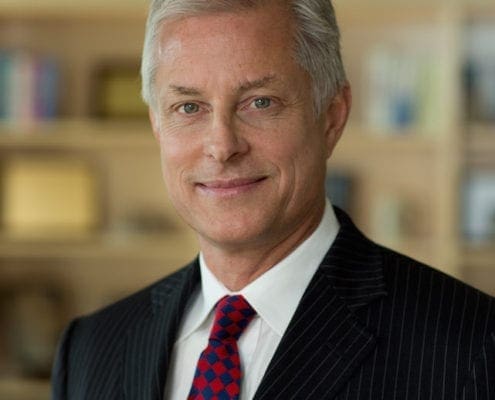 Smiling gray-haired man in suit and tie