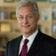 Smiling gray-haired man in suit and tie
