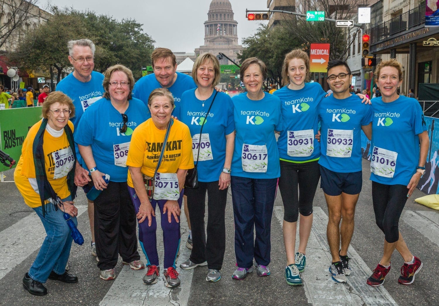 Group of runners in blue shirts at race Group of runners in blue shirts at race