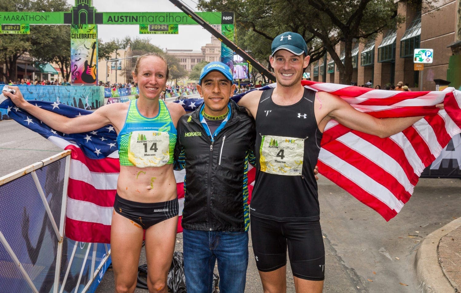 Three Austin Marathon finishers with American flag Three Austin Marathon finishers with American flag