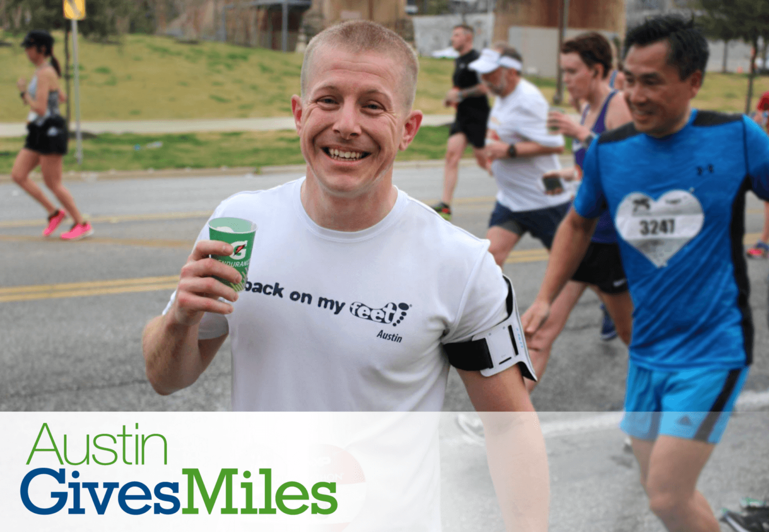 Smiling runner holding cup during Austin race