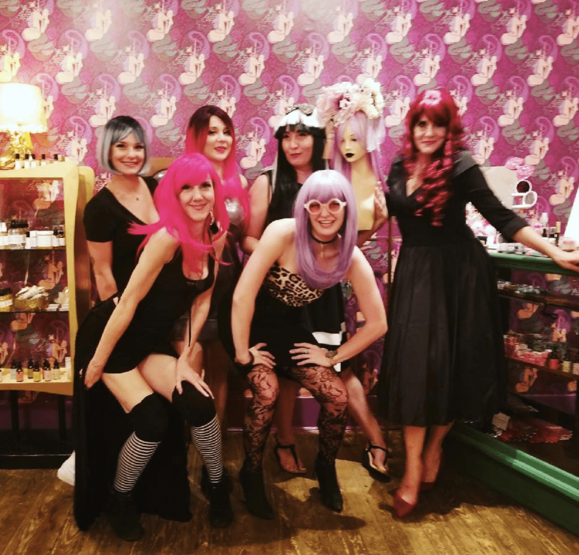 Group of women in colorful wigs and costumes Group of women in colorful wigs and costumes
