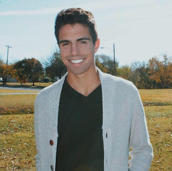 Smiling young man in cardigan outdoors Smiling young man in cardigan outdoors