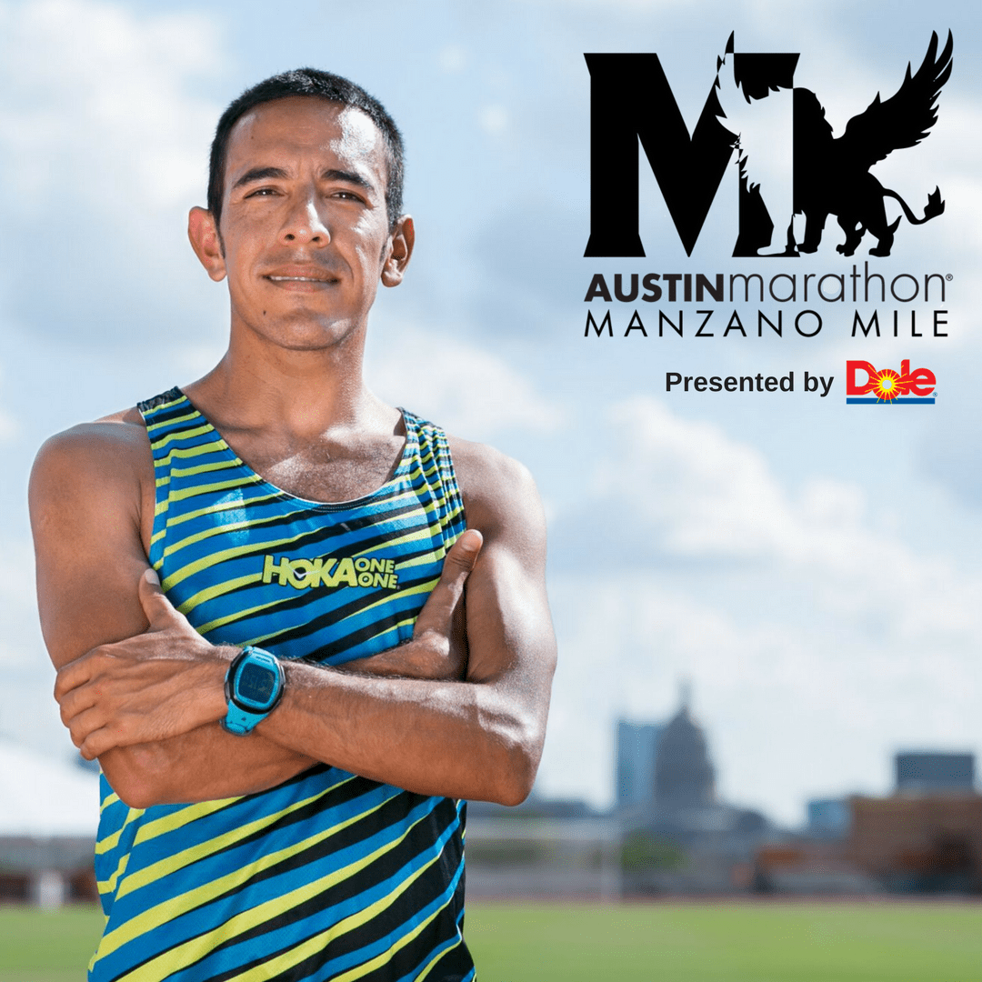 Runner posing with Austin skyline and logo