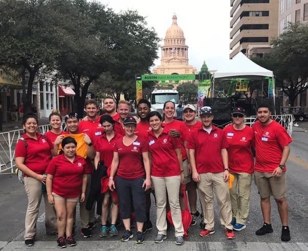 Group of red-shirt volunteers in front of capitol