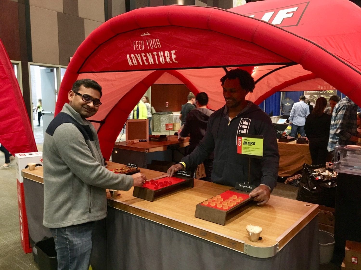 Austin Marathon expo Two men playing tabletop game under red tent