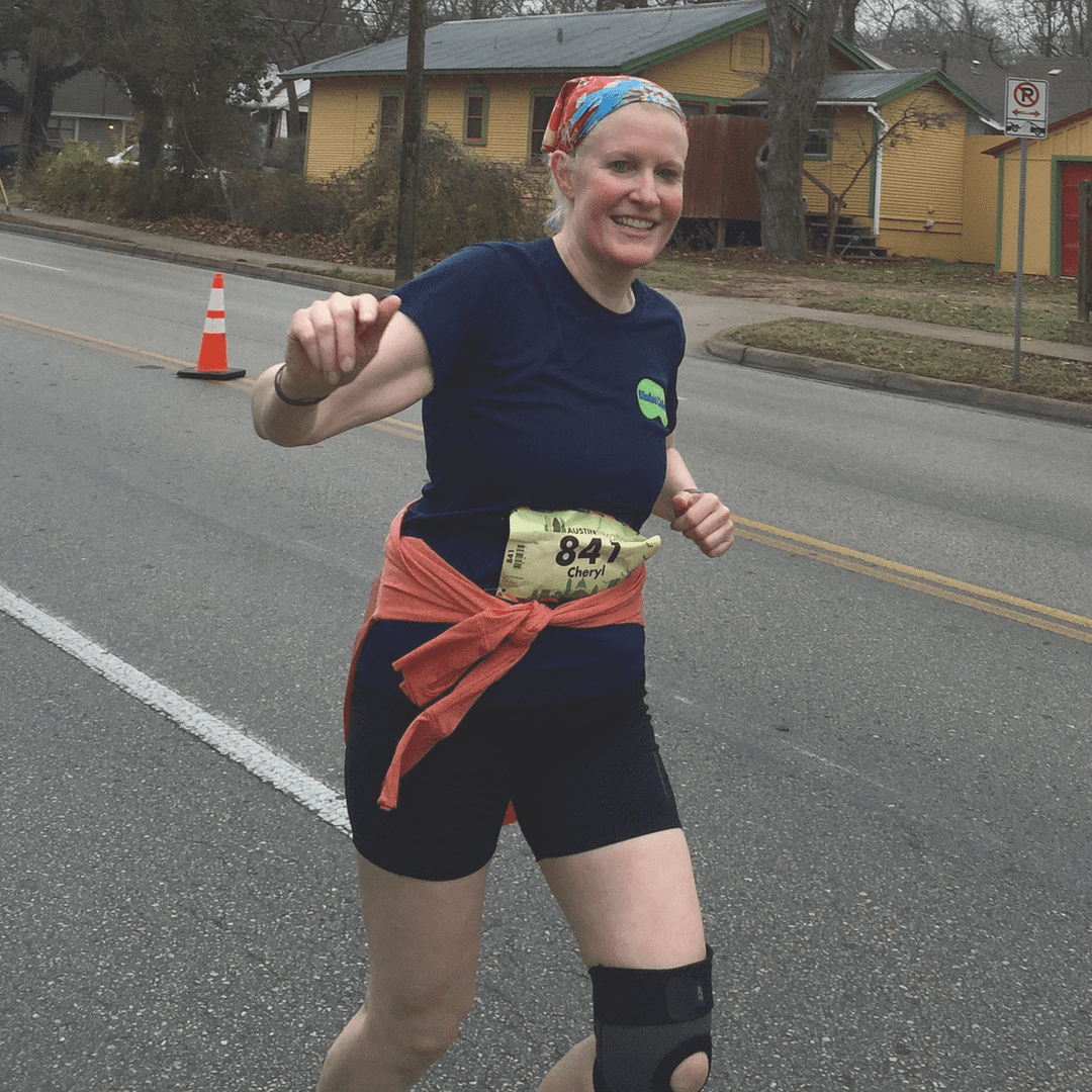 Smiling woman runner wearing knee brace Smiling woman runner wearing knee brace