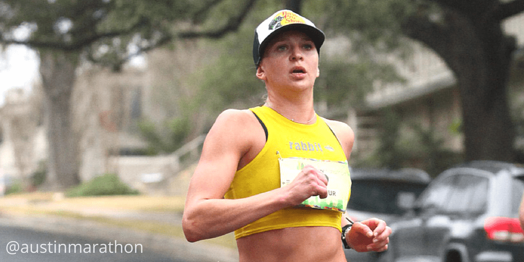 Marathon runner wearing yellow top and cap