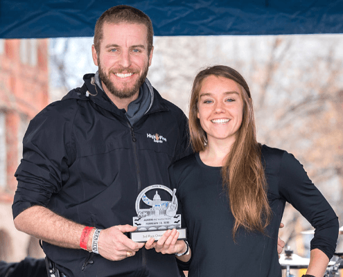 Two smiling people holding a trophy Two smiling people holding a trophy