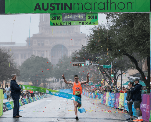 Austin Marathon finish line winner with confetti Austin Marathon finish line winner with confetti