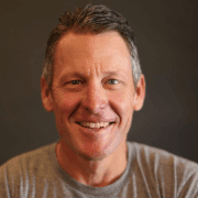 Smiling middle-aged man against dark background