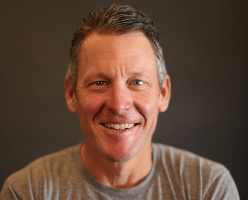Smiling middle-aged man against dark background