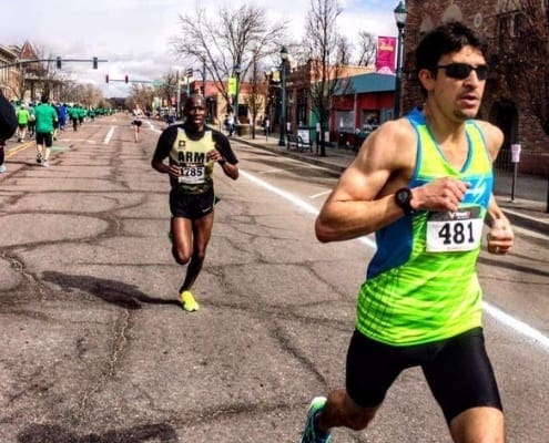 Two runners racing on city street