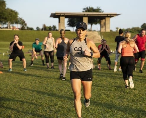 Woman leading outdoor group fitness class Woman leading outdoor group fitness class