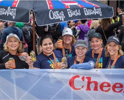 Group of women smiling with beer cups