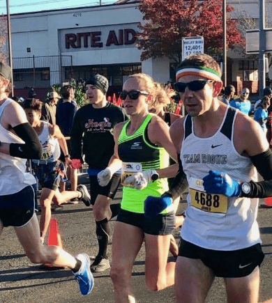 Road race runners passing Rite Aid store