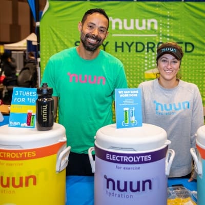 Smiling staff at Nuun hydration booth