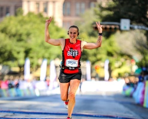 Runner celebrating at the finish line
