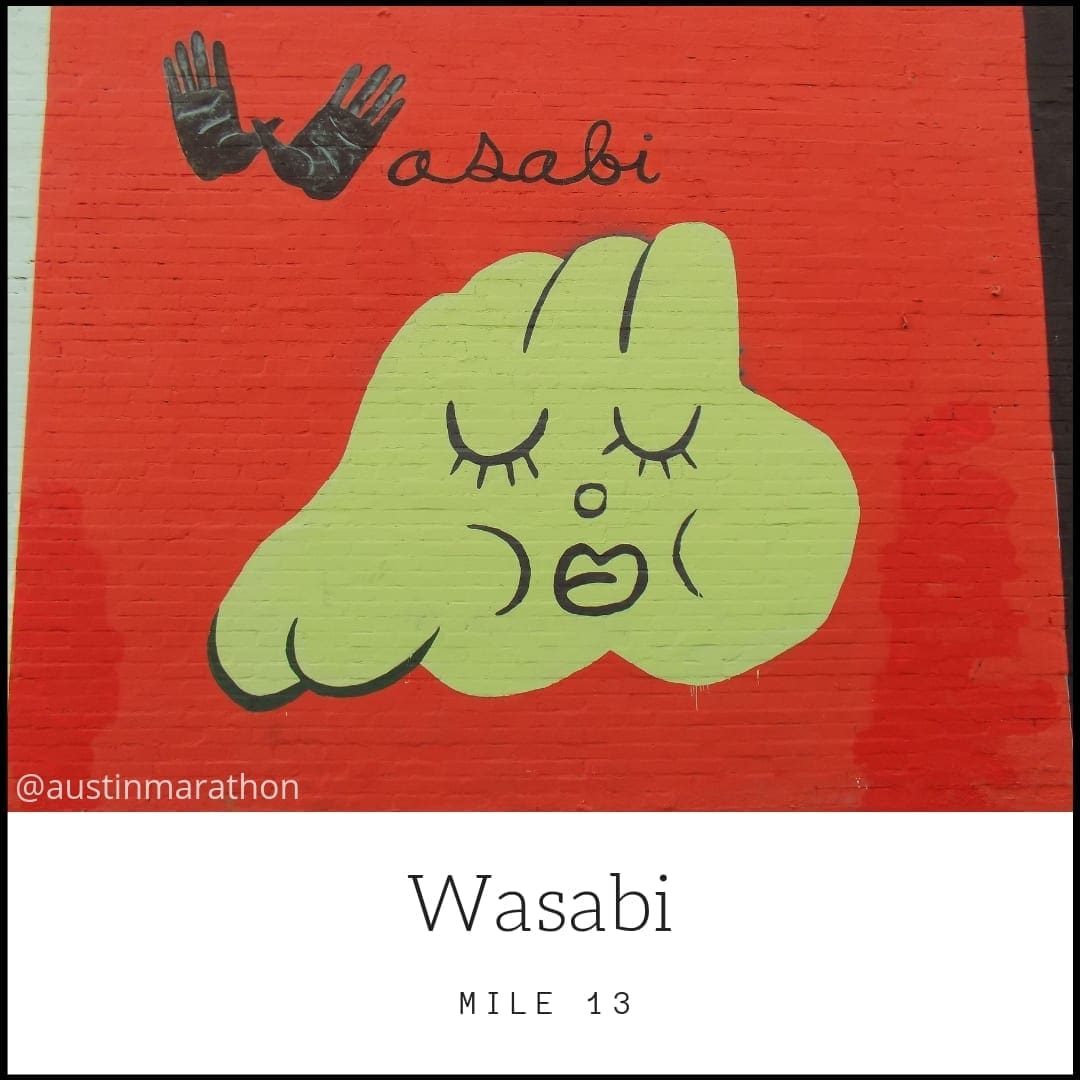 Green wasabi cartoon face mural on red Green wasabi cartoon face mural on red