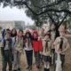 Group of Boy Scouts posing outdoors under tree