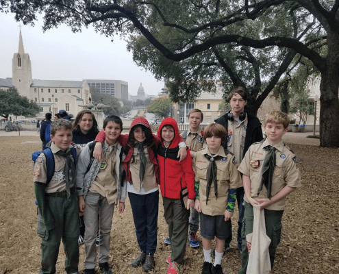 Group of Boy Scouts posing outdoors under tree