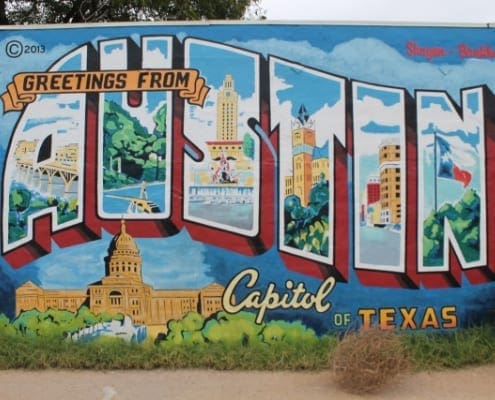 Colorful "Greetings from Austin" mural with Capitol