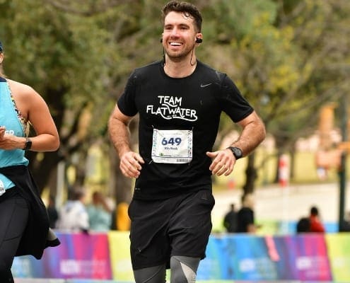 Smiling runner in Team Flatwater shirt