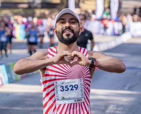 Runner forming heart gesture during race