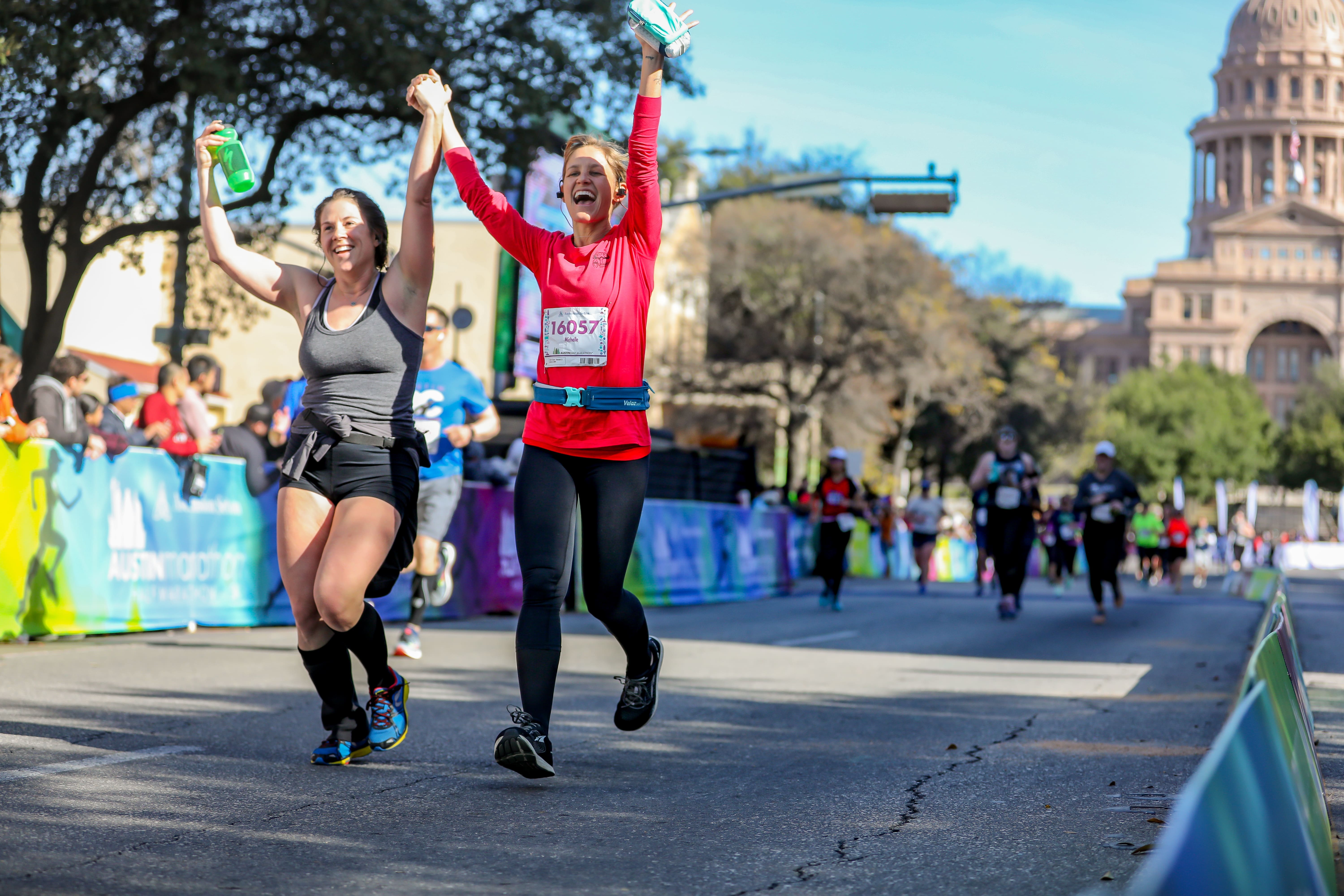 Runners cross the 2019 Austin Marathon finish line and see each other's improvement.