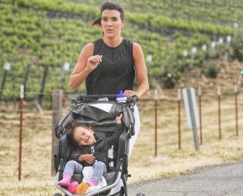 Samantha pushing her daughter in a jogging stroller, building their unbreakable bond. Samantha pushing her daughter in a jogging stroller, building their unbreakable bond.