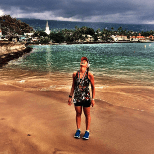 person standing on tropical beach looking up