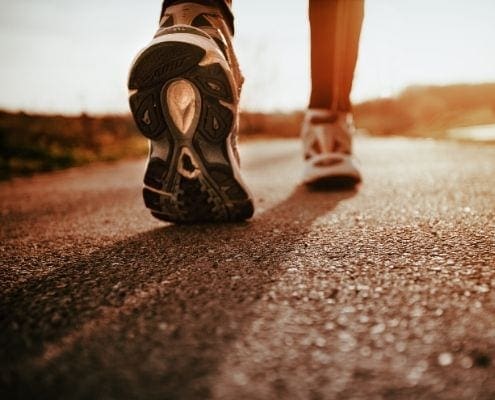 Image of runner walking on concrete on their life-changing journey. Image of runner walking on concrete on their life-changing journey.