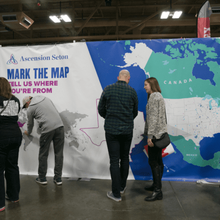 Visitors marking large world map display