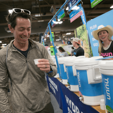 Man tasting sample at blue cooler booth