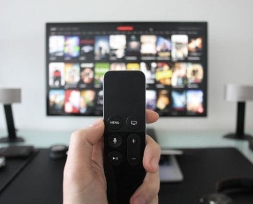 Remote control pointed at streaming TV screen Remote control pointed at streaming TV screen