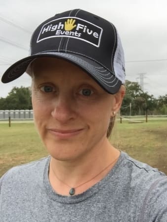 Person wearing "High Five Events" cap outdoors