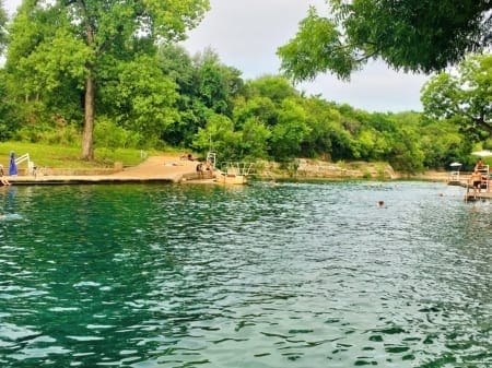 River swimming area with docks and trees