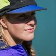 Woman wearing blue cap and purple jacket Woman wearing blue cap and purple jacket