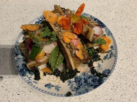 Roasted bone marrow with microgreens and flowers
