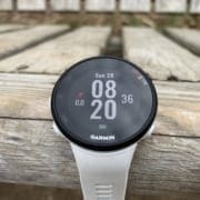 White Garmin smartwatch on wooden bench White Garmin smartwatch on wooden bench