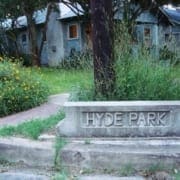 Hyde Park carved stone sign by cottages