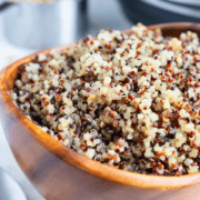 Cooked tri-color quinoa in wooden bowl