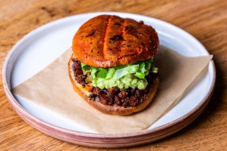 Toasted bun burger with lettuce on plate